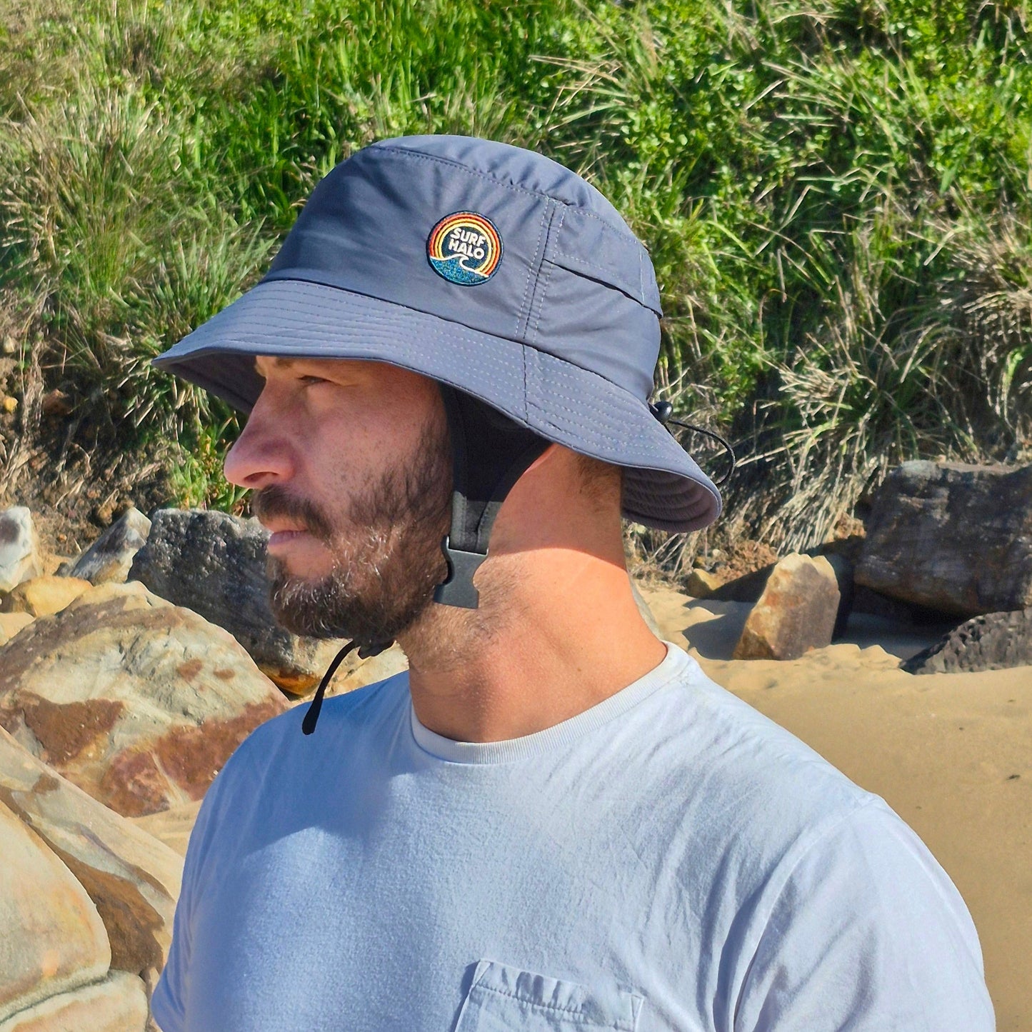 Men wearing surf hat charcoal grey bucket hat style with helmet insert chin strap adjustable