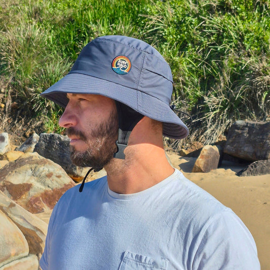 Men wearing surf hat charcoal grey bucket hat style with helmet insert chin strap adjustable