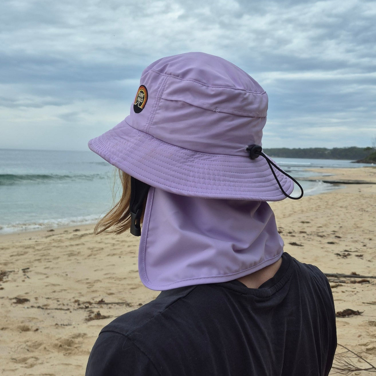surf hat helmet removable back flap on a girl on the beach