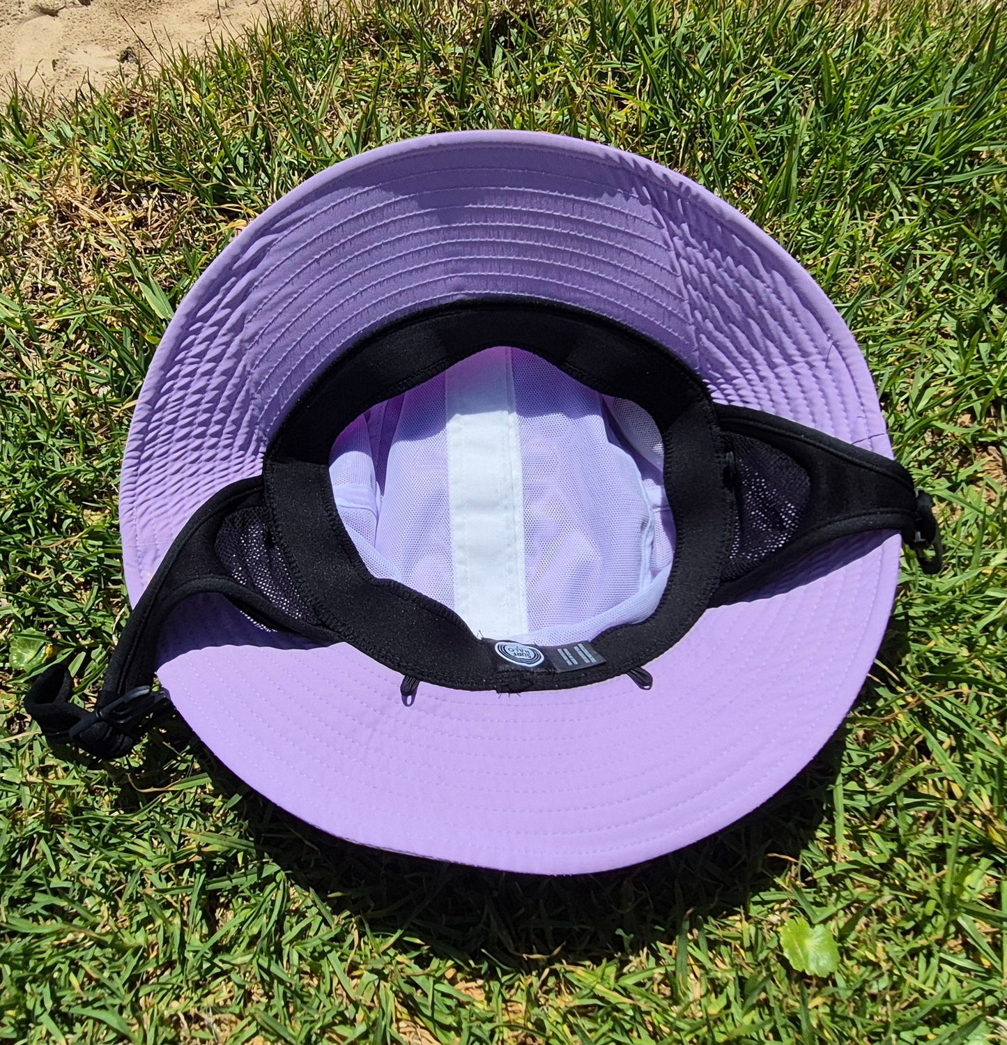 Pink bucket hat on grass inside view