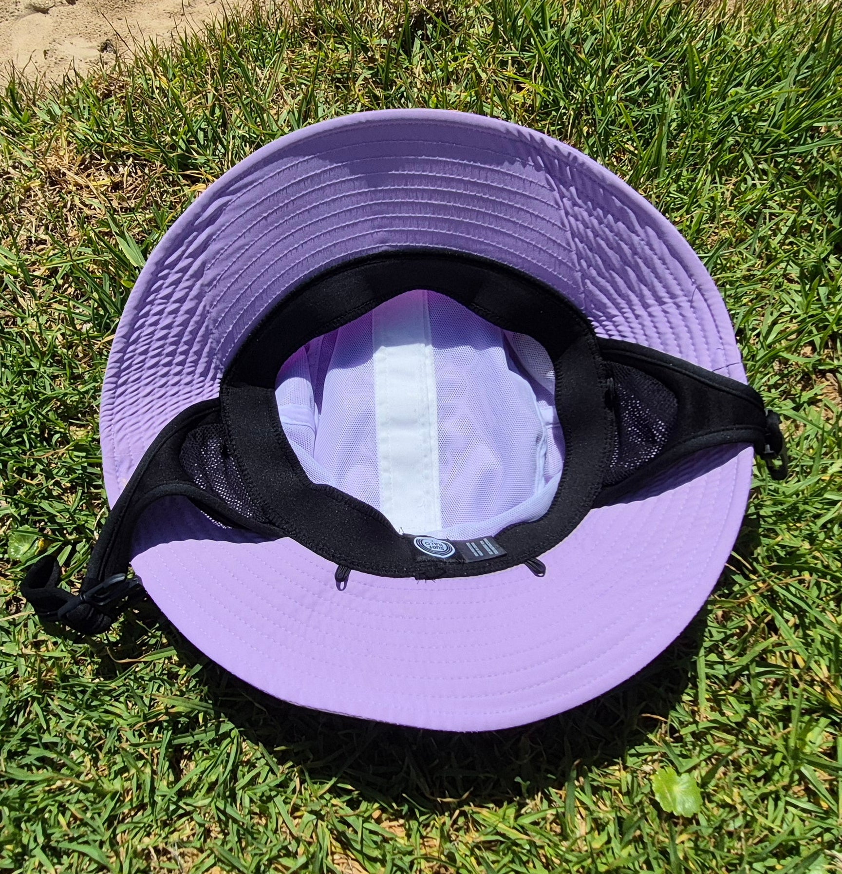 Pink bucket hat on grass inside view